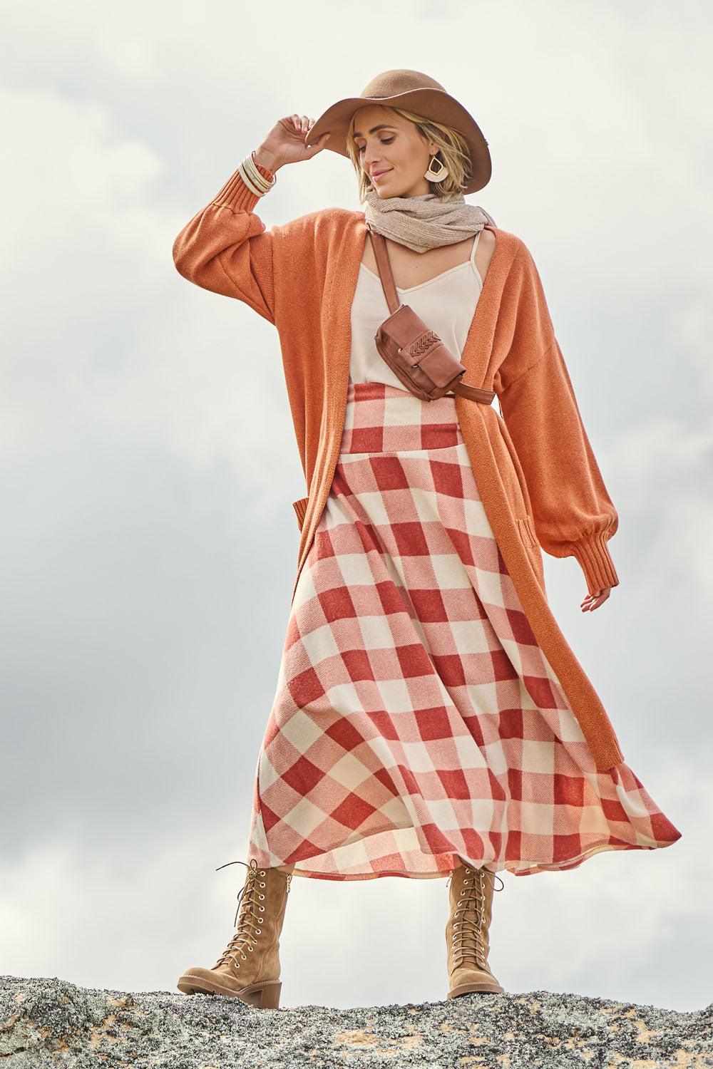 Model Tegan wearing size 10 of the Chasing The Clouds Away Maxi Skirt in colour Rust (Red), from the front, showing the whole outfit