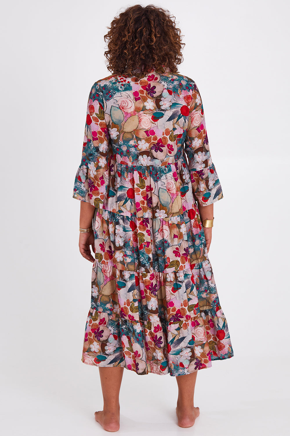 Model Anucia wearing size 14 of the Its Easy Loving You Tiered Dress in colour Fleur (Green), from the back