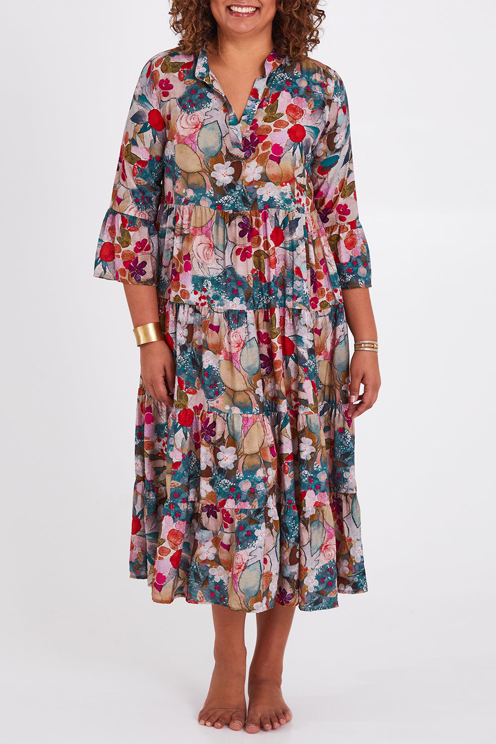 Model Anucia wearing size 14 of the Its Easy Loving You Tiered Dress in colour Fleur (Green), from the front, cropped image