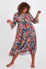 Model Anucia wearing size 14 of the Its Easy Loving You Tiered Dress in colour Fleur (Green), from the front, showing the whole outfit