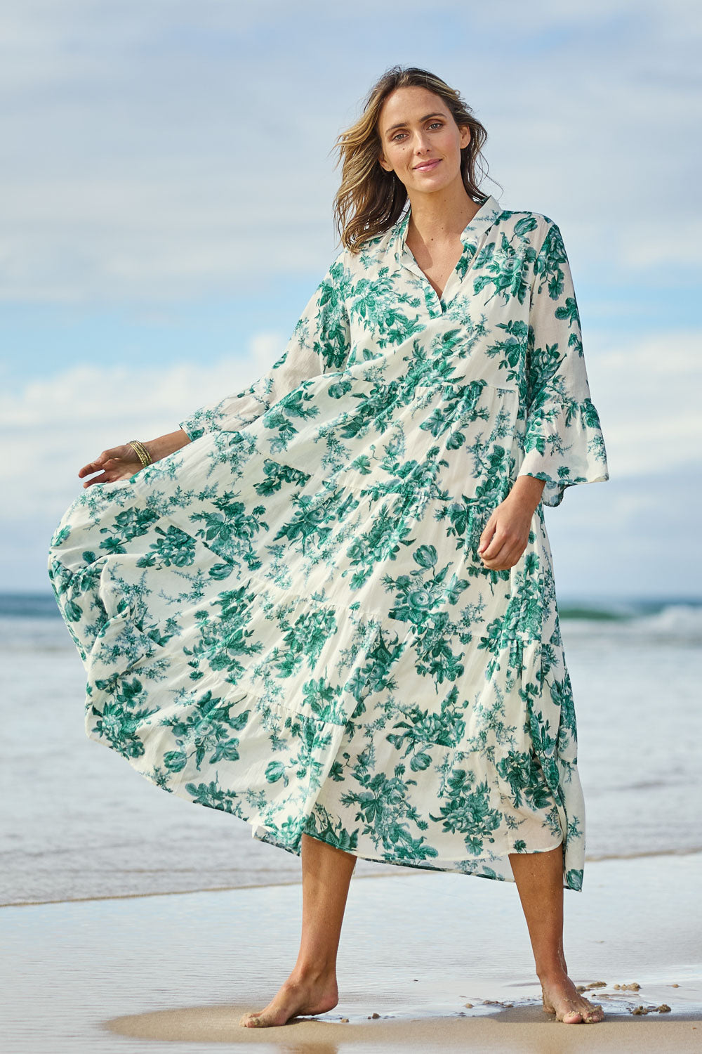 Model Tegan wearing size 10 of the Its Easy Loving You Tiered Dress in colour Greenfleur (Green), from the front, showing the whole outfit