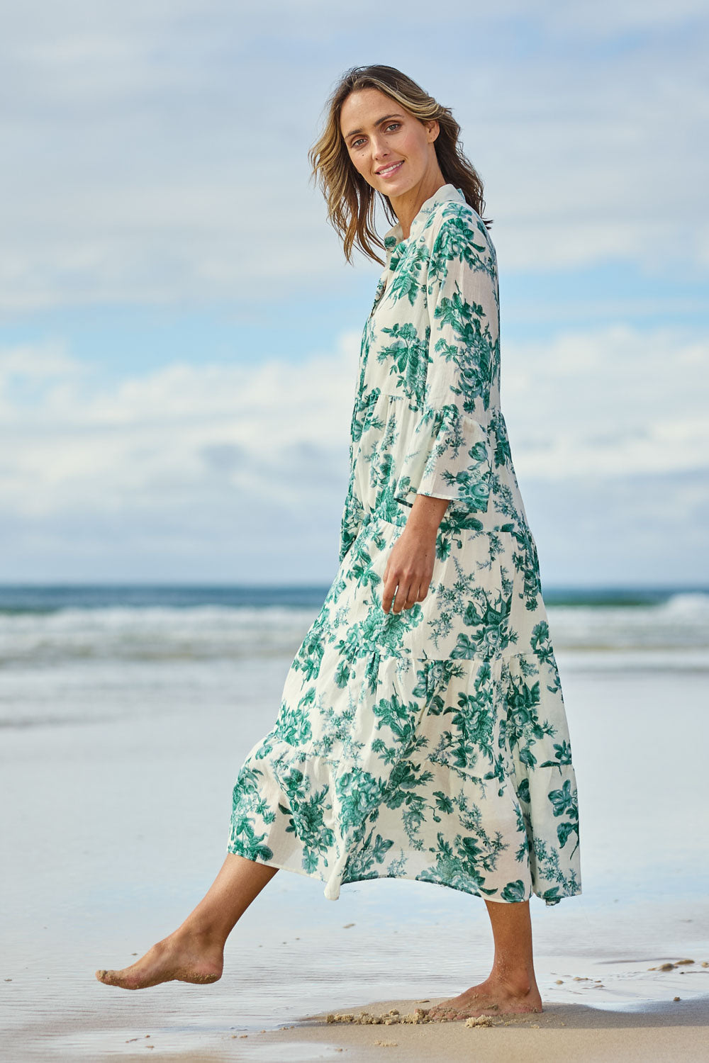 Model Tegan wearing size 10 of the Its Easy Loving You Tiered Dress in colour Greenfleur (Green), from the front, showing the whole outfit