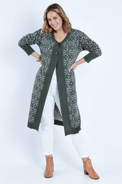 Model Jess wearing size L of the Fields Of Folly Cardi in colour Forest (Green), from the front, showing the whole outfit