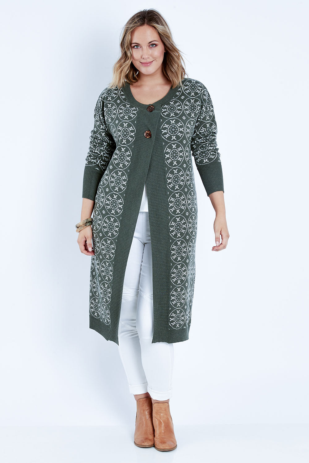 Model Jess wearing size L of the Fields Of Folly Cardi in colour Forest (Green), from the front, showing the whole outfit