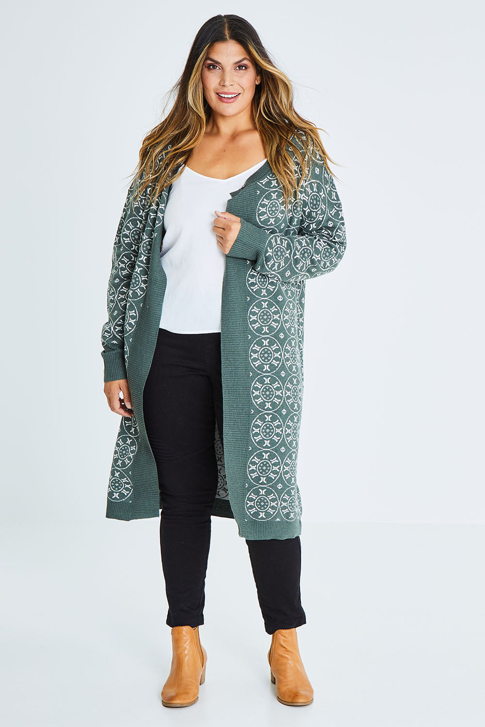 Model Palatina wearing size XL of the Fields Of Folly Cardi in colour Forest (Green), from the front, showing the whole outfit