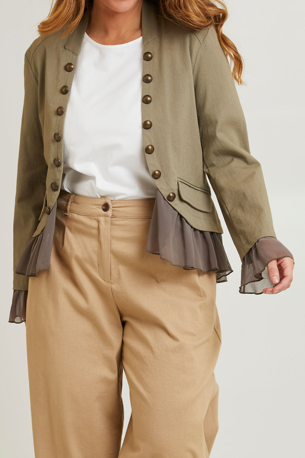 Model Laura wearing size 14 of the Commander Of Love Jacket in colour Khaki (Green), from the front, cropped image