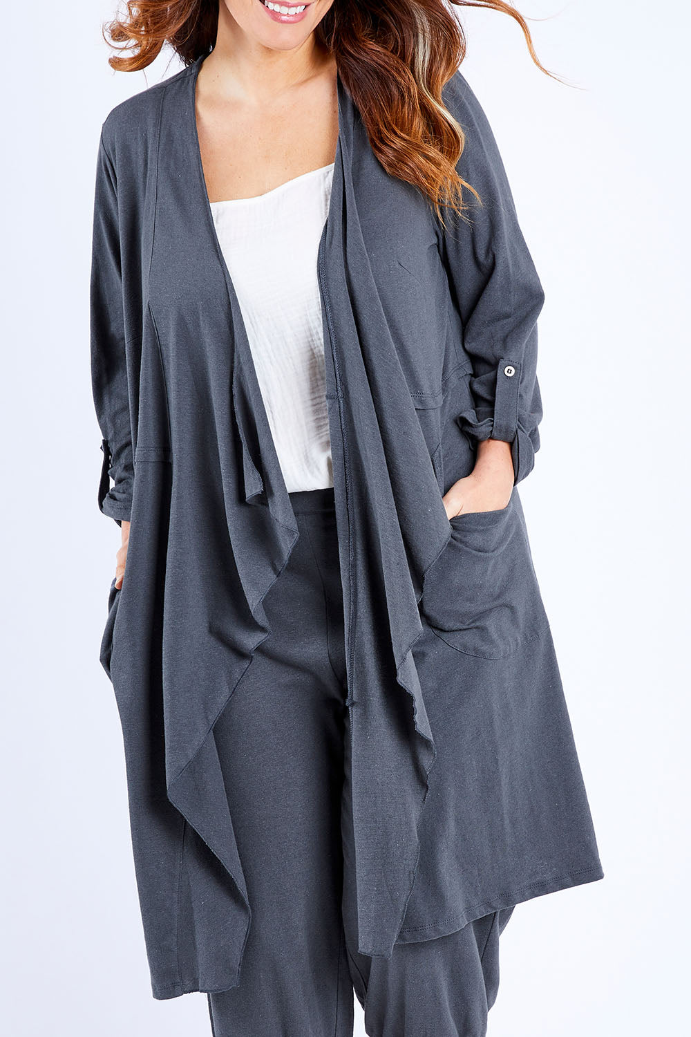 Model Laura wearing size 14 of the Elegant Slumming Cardi in colour Slate (Grey), from the front, cropped image
