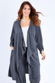 Model Laura wearing size 14 of the Elegant Slumming Cardi in colour Slate (Grey), from the front, cropped image