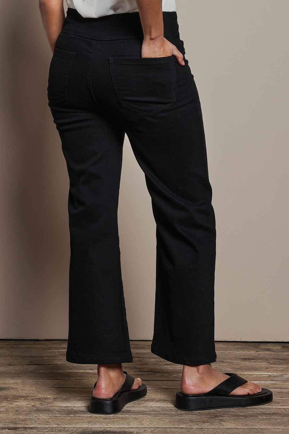 Model Tahnee wearing size 10 of the Easy As Plain Pull On Jeans in colour Black (Black), from the back