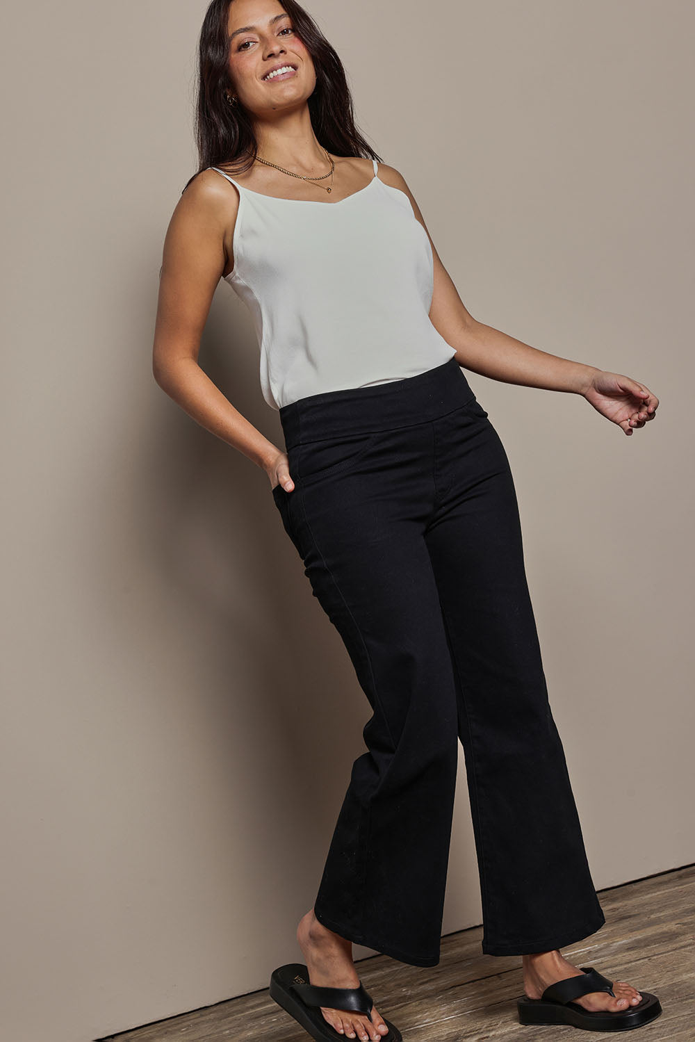 Model Tahnee wearing size 10 of the Easy As Plain Pull On Jeans in colour Black (Black), from the front, showing the whole outfit