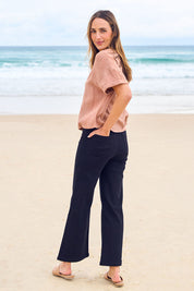 Model Tegan wearing size 10 of the Easy As Plain Pull On Jeans in colour Black (Black), from the front, showing the whole outfit