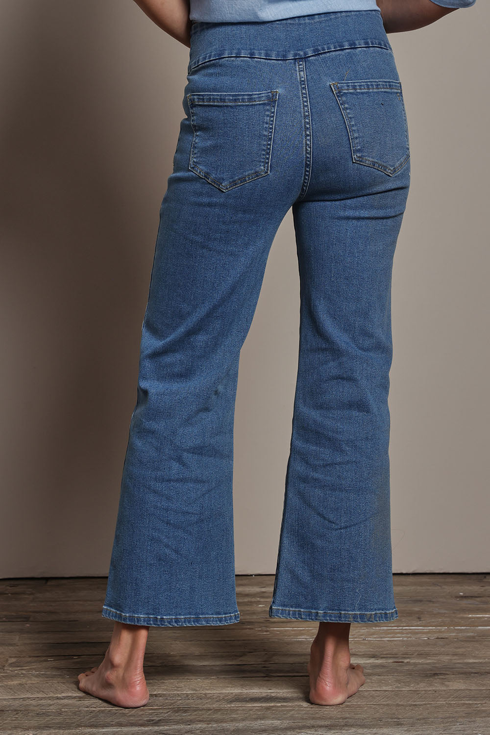 Model Amanda wearing size 10 of the Easy As Plain Pull On Jeans in colour Denim (Blue), from the back