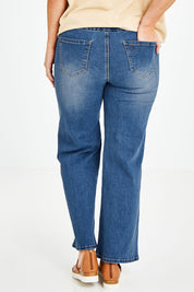 Model Laura wearing size 14 of the Easy As Pull On Jeans in colour Denim (Blue), from the back