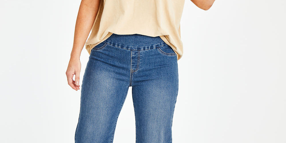 Model Laura wearing size 14 of the Easy As Pull On Jeans in colour Denim (Blue), from the front, showing the whole outfit