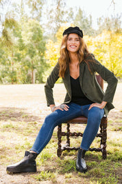 Model Ilona wearing size 10 of the Highland Cord Blazer in colour Pine (Green), from the front, showing the whole outfit