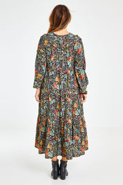 Model Laura wearing size 14 of the Field Of Flowers Dress in colour Black (Black), from the back