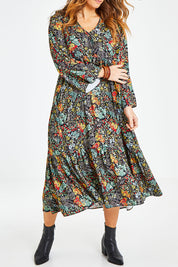 Model Laura wearing size 14 of the Field Of Flowers Dress in colour Black (Black), from the front, cropped image