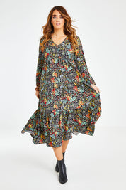 Model Laura wearing size 14 of the Field Of Flowers Dress in colour Black (Black), from the front, showing the whole outfit