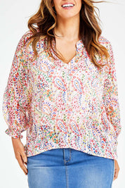Model Laura wearing size 14 of the Bright As A Button Blouse in colour Confetti (White), from the front, showing the whole outfit