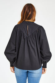 Model Laura wearing size 14 of the Lady Whistledown Blouse in colour Black (Black), from the back