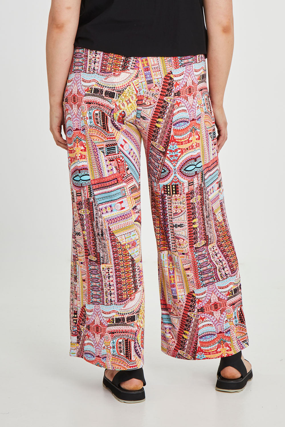 Model Keeara wearing size 16 of the Pretty Patch Pants in colour Bright (Red), from the back