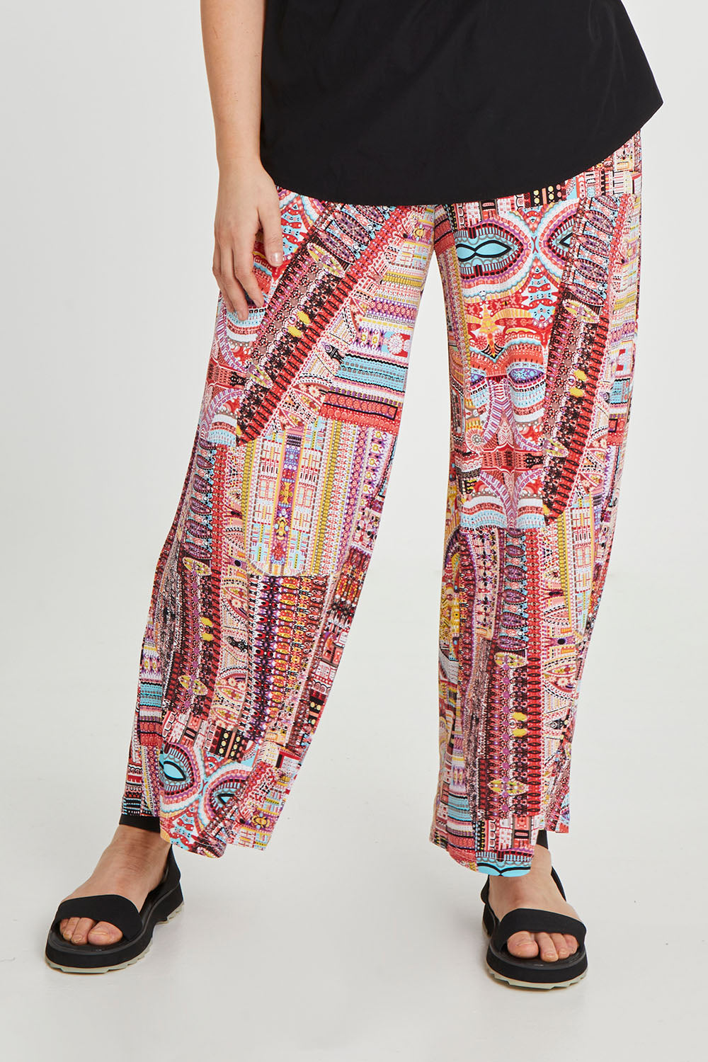Model Keeara wearing size 16 of the Pretty Patch Pants in colour Bright (Red), from the front, cropped image
