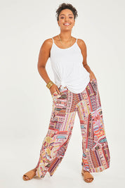 Model Noli wearing size 14 of the Pretty Patch Pants in colour Bright (Red), from the front, showing the whole outfit