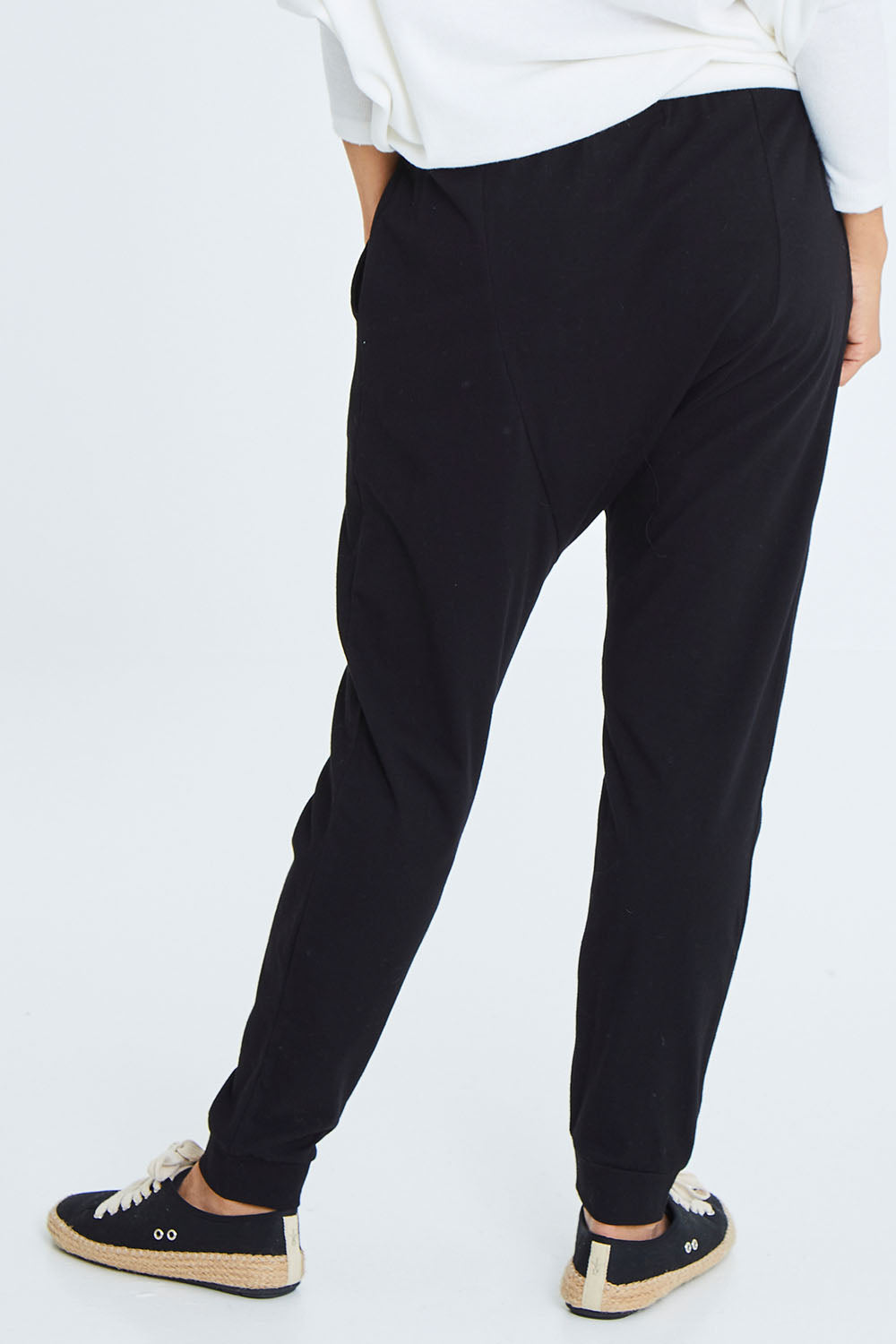 Model Cara wearing size 10 of the Easy Living Pants in colour Black (Black), from the back