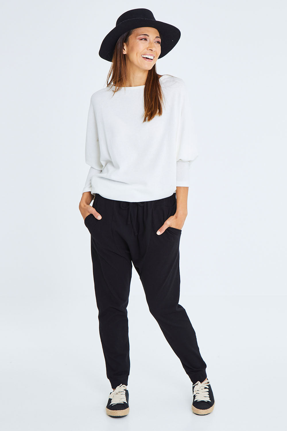 Model Cara wearing size 10 of the Easy Living Pants in colour Black (Black), from the front, showing the whole outfit