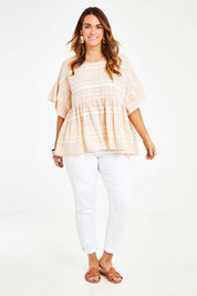 Model Laura wearing size 14 of the Perfect As You Are Stripe Top in colour Peach (Pink), from the front, showing the whole outfit