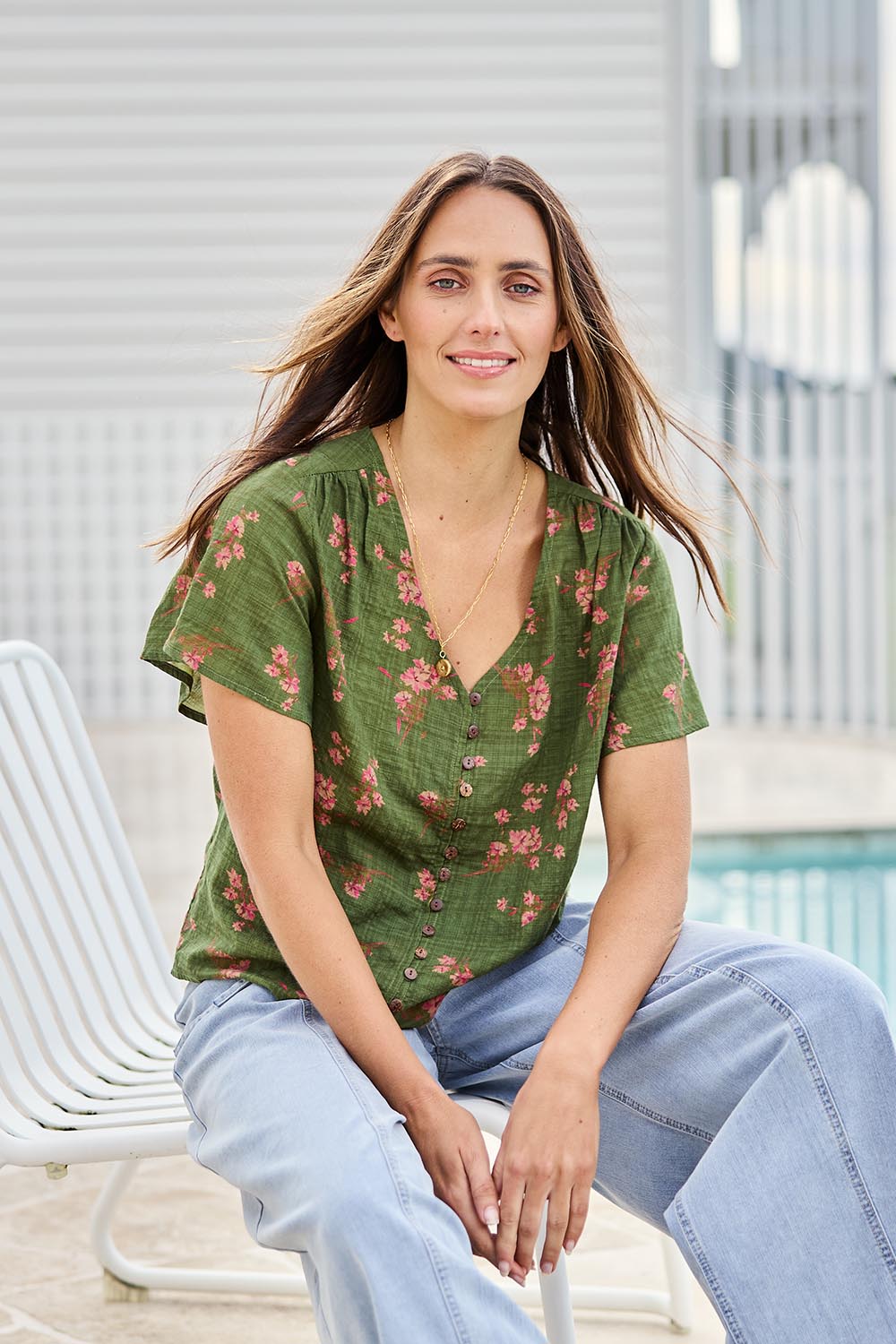 Model Tegand wearing size 10 of the Cute As A Button Printed Blouse - Greenpink in colour Greenpink, in a cropped view