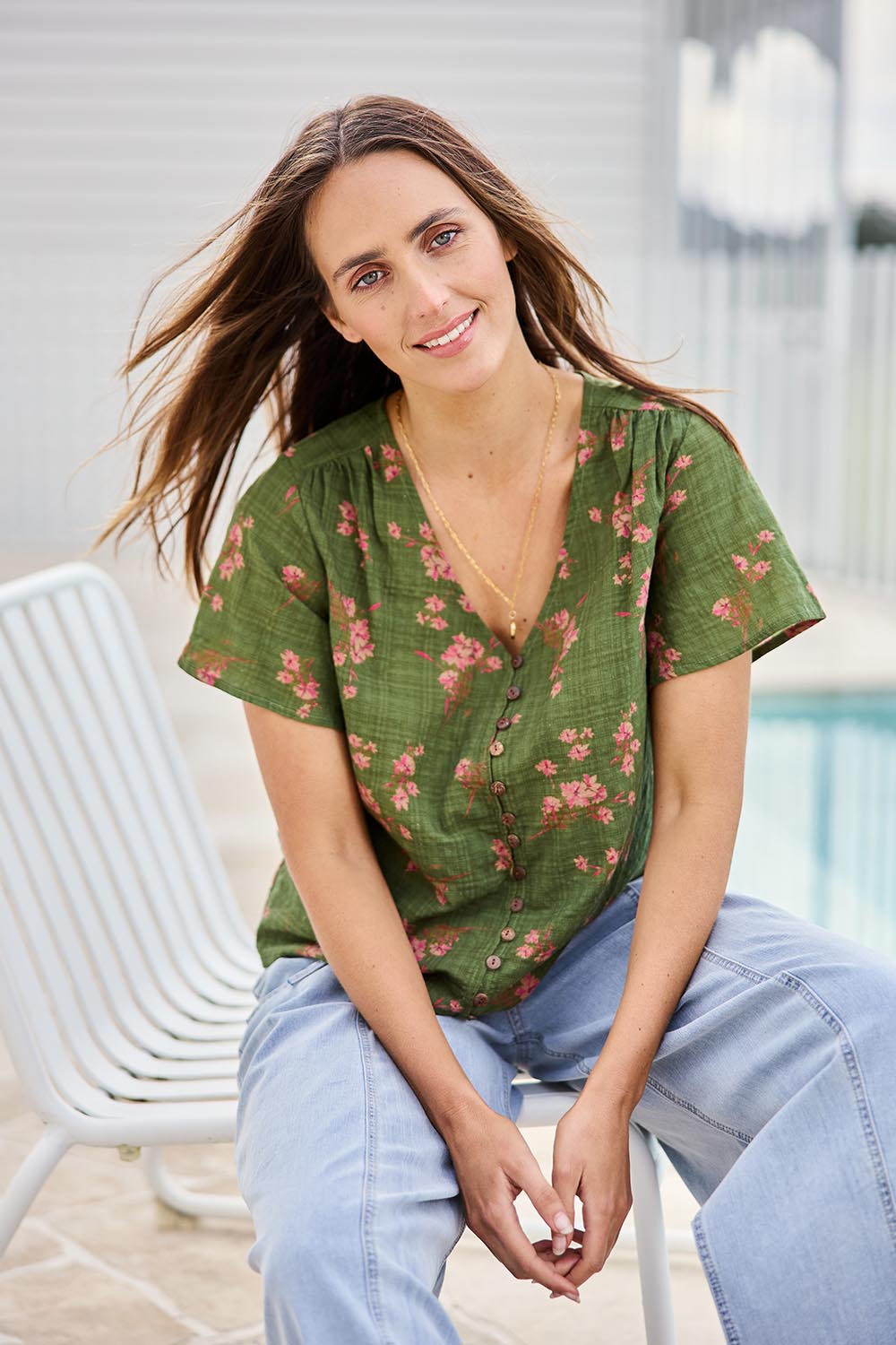 Model Tegand wearing size 10 of the Cute As A Button Printed Blouse - Greenpink in colour Greenpink, in a cropped view