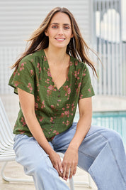 Model Tegand wearing size 10 of the Cute As A Button Printed Blouse - Greenpink in colour Greenpink, in a cropped view