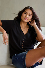 Model Tahnee wearing size 10 of the Cute As A Button Blouse in colour Black (Black), from the front, showing the whole outfit