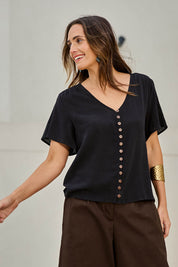 Model Tegand wearing size 10 of the Cute As A Button Cotton Blouse - Black in colour Black, in a cropped view