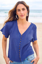 Model Tegand wearing size 10 of the Cute As A Button Cotton Blouse - Blue in colour Blue, in a cropped view
