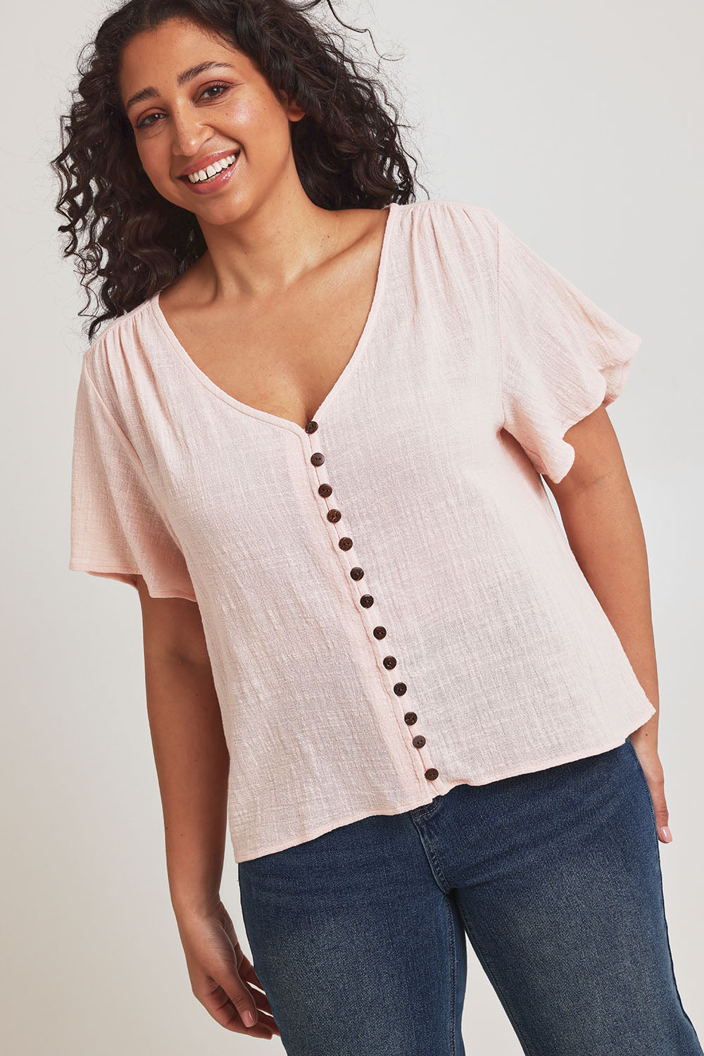 Model Terri-Leigh wearing size 14 of the Cute As A Button Blouse in colour Blush (Pink), from the front, cropped image
