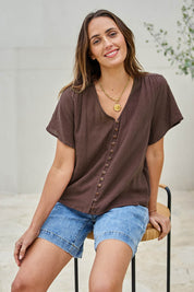 Model Tegand wearing size 10 of the Cute As A Button Blouse – Chocolate in colour Chocolate, in a cropped view