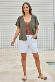 Model Tegand wearing size 10 of the Cute As A Button Blouse – Forrest in colour Forrest, from the front