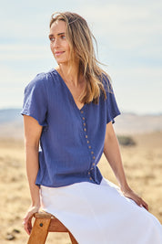 Model Tegan wearing size 10 of the Cute As A Button Blouse in colour Frenchblue (Blue), from the front, cropped image