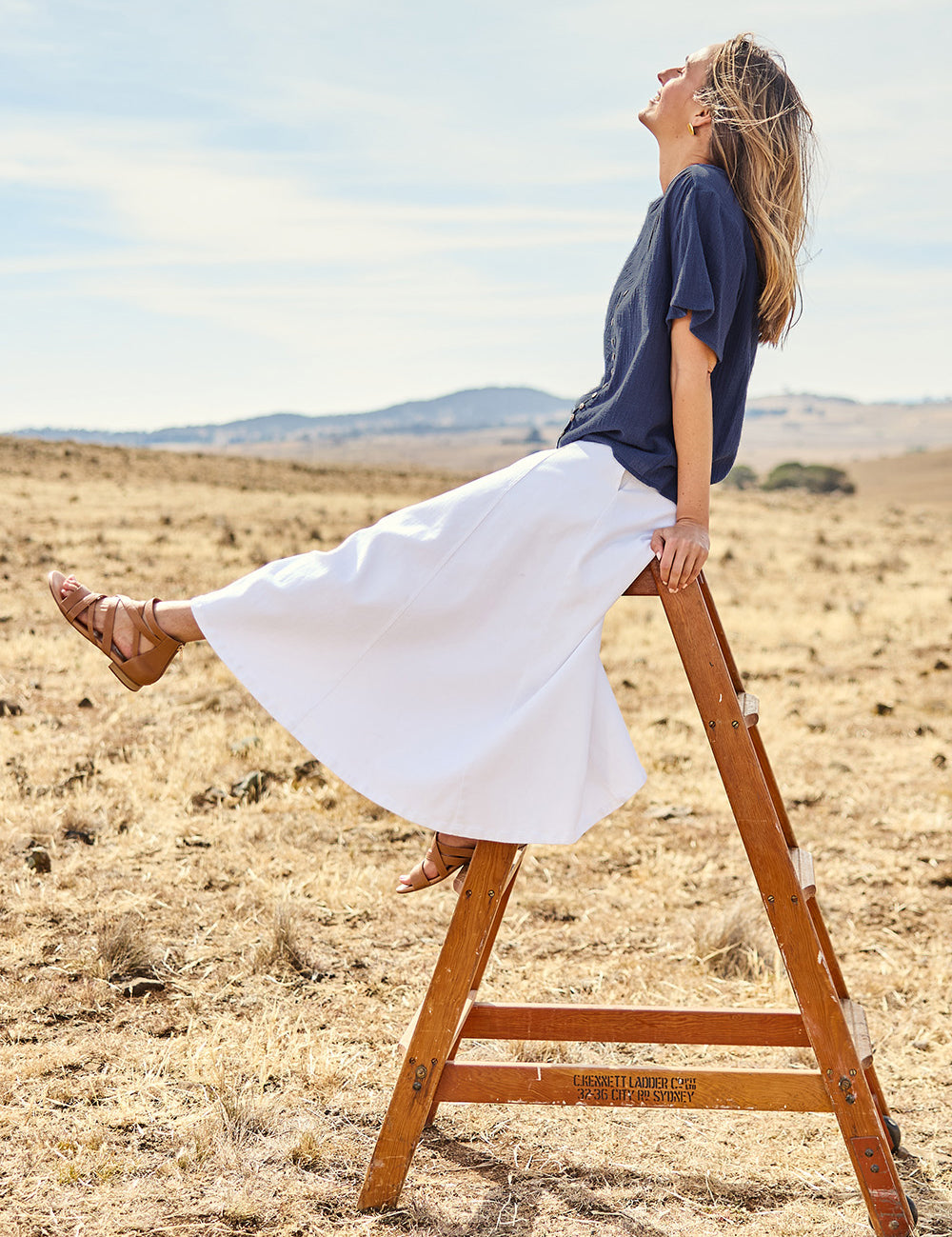 Model Tegand wearing size 10 of the Cute As A Button Cotton Blouse - Frenchblue in colour Frenchblue, from the front
