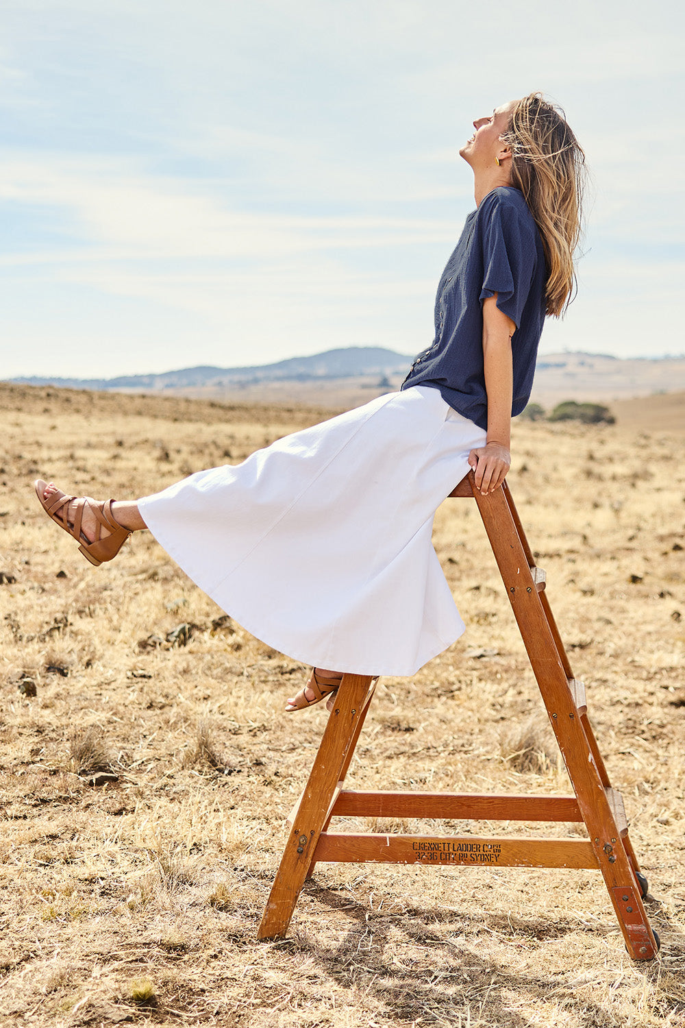 Model Tegand wearing size 10 of the Cute As A Button Cotton Blouse - Frenchblue in colour Frenchblue, from the front