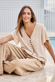 Model Tegand wearing size 10 of the Cute As A Button Blouse - Natural in colour Natural, from the front