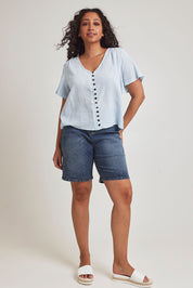 Model Terri-Leigh wearing size 14 of the Cute As A Button Blouse in colour Sky (Blue), from the front, showing the whole outfit
