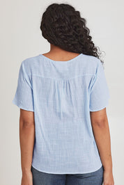 Model Terri Leighj wearing size 14 of the Cute As A Button Cotton Blouse - Sky in colour Sky, from the back