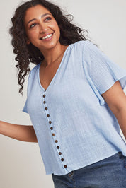 Model Terri Leighj wearing size 14 of the Cute As A Button Cotton Blouse - Sky in colour Sky, in a cropped view