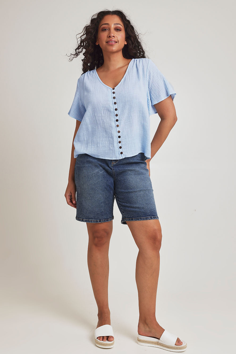 Model Terri Leighj wearing size 14 of the Cute As A Button Cotton Blouse - Sky in colour Sky, from the front