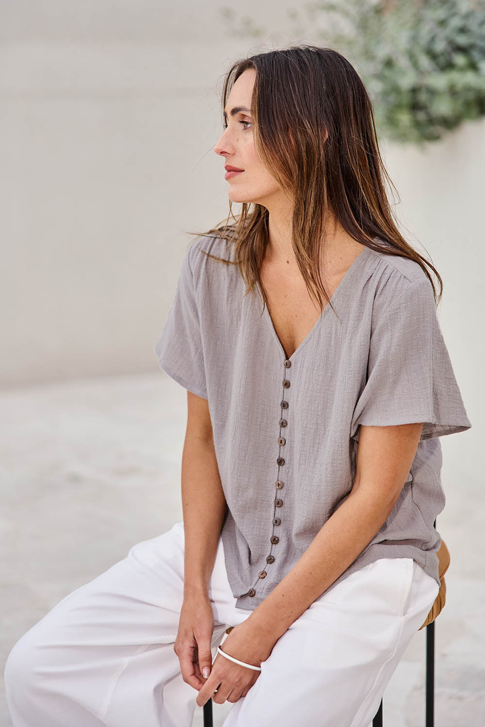 Model Tegand wearing size 10 of the Cute As A Button Cotton Blouse – Smoke in colour Smoke, from an angle