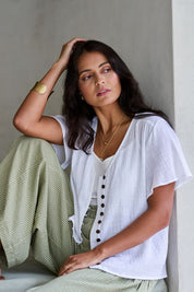 Model Tahnee wearing size 10 of the Cute As A Button Blouse in colour White (White), from the front, showing the whole outfit