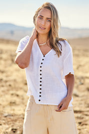 Model Tegan wearing size 10 of the Cute As A Button Blouse in colour White (White), from the front, cropped image
